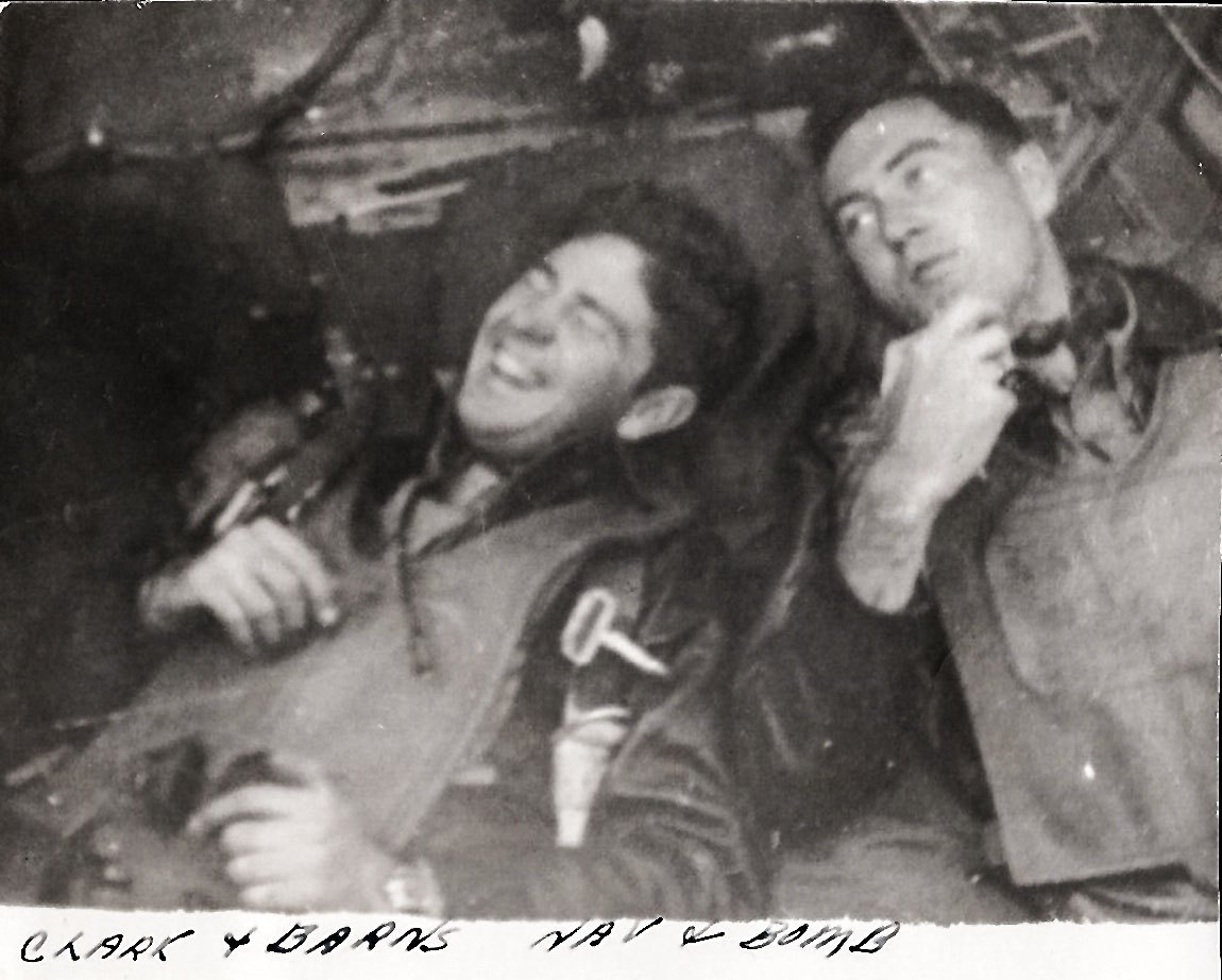 Two airmen in a B-17 nose, the print labeled CLARK and BARNS, NAV and BOMB