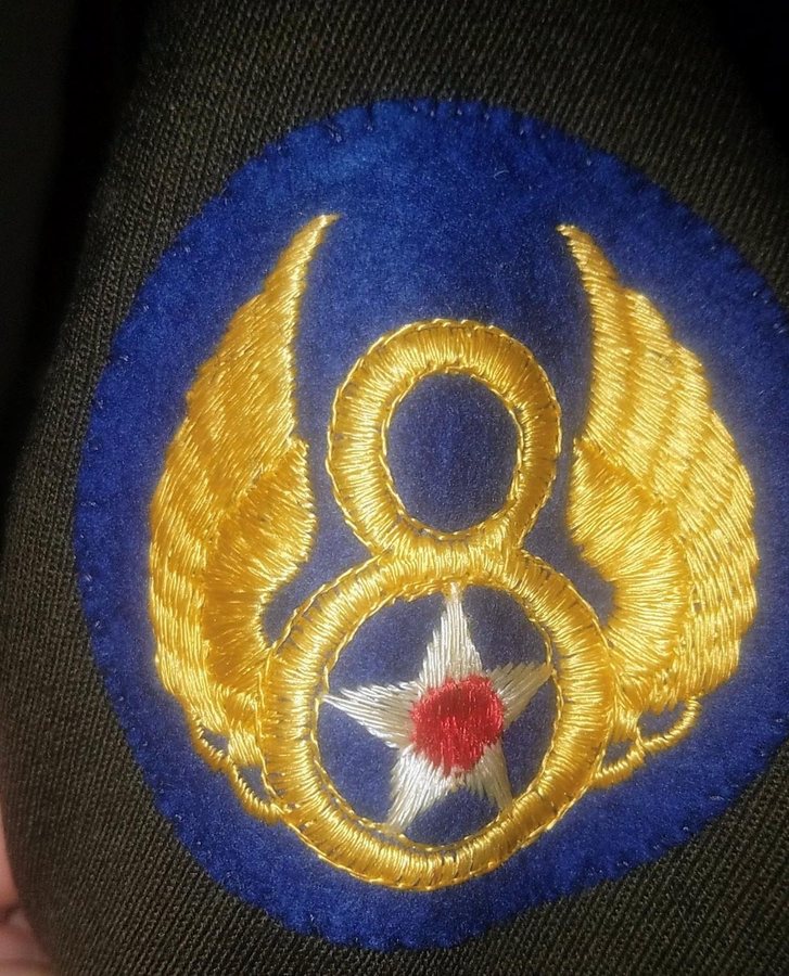 Embroidered Eighth Air Force shoulder patch: a golden winged 8 on blue, a white star with a red center